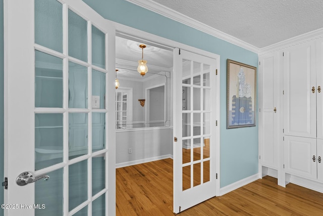 1205 Logan Ct, Jacksonville, NC 28540 - interior space featuring wood finished floors, crown molding, baseboards, a textured ceiling, and french doors