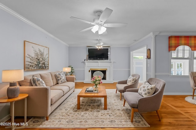 1205 Logan Ct, Jacksonville, NC 28540 - living area featuring ornamental molding, light wood-type flooring, ceiling fan, a brick fireplace, and baseboards