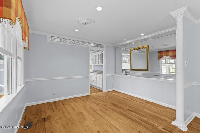 1205 Logan Ct, Jacksonville, NC 28540 - empty room featuring ornamental molding, wood finished floors, baseboards, recessed lighting, and decorative columns