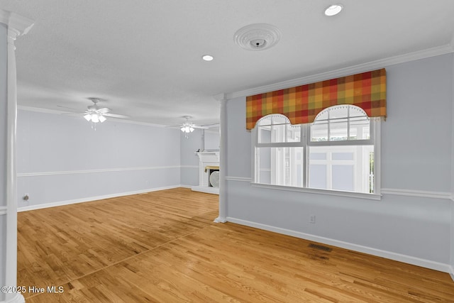 1205 Logan Ct, Jacksonville, NC 28540 - unfurnished living room featuring crown molding, ceiling fan, a fireplace, baseboards, and wood finished floors