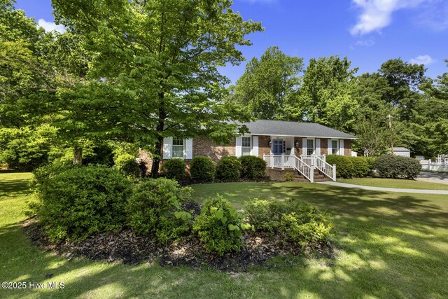 1205 Logan Ct, Jacksonville, NC 28540 - view of front of house with brick siding and a front yard