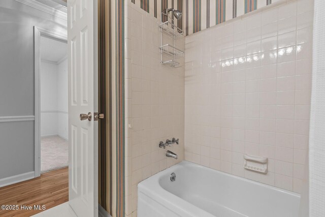 1205 Logan Ct, Jacksonville, NC 28540 - bathroom with wood finished floors, washtub / shower combination, and baseboards