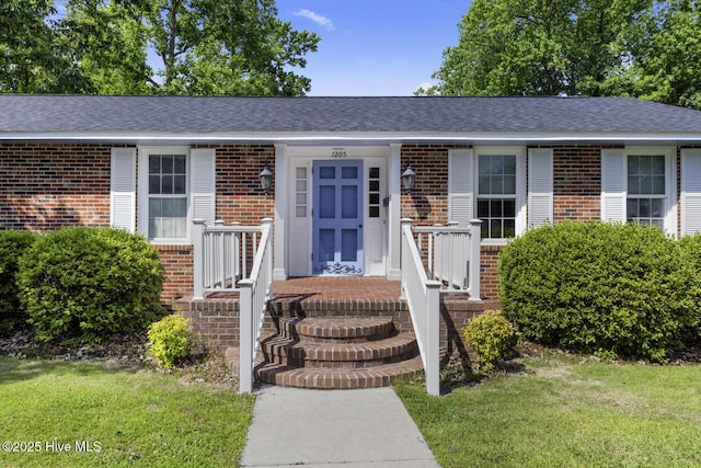 1205 Logan Ct, Jacksonville, NC 28540 - view of front of house featuring brick siding and a front yard