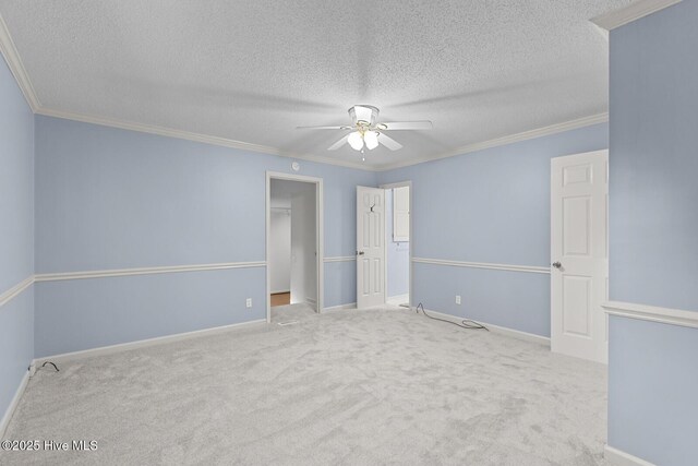 1205 Logan Ct, Jacksonville, NC 28540 - unfurnished bedroom with carpet floors, a textured ceiling, ornamental molding, baseboards, and a walk in closet