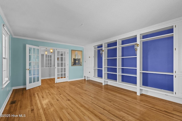 1205 Logan Ct, Jacksonville, NC 28540 - unfurnished room featuring french doors, ornamental molding, wood finished floors, baseboards, and a textured ceiling