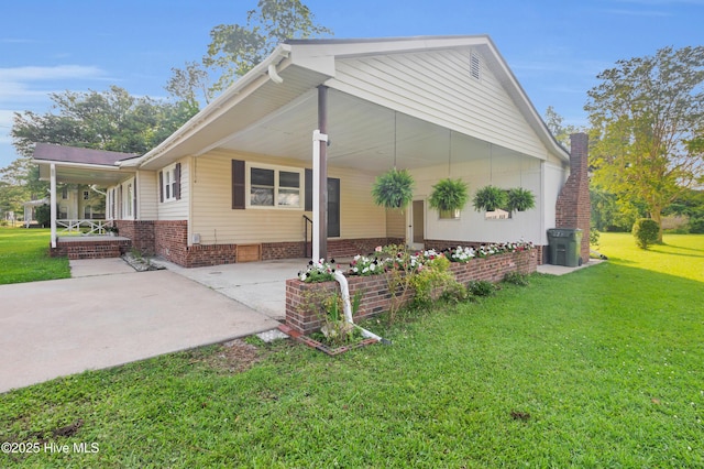 208 Buck Ln, Vanceboro, NC 28586 - view of home's exterior with a yard, an attached carport, concrete driveway, and a porch