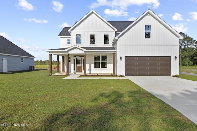 411 Fore Pl, Jacksonville, NC 28540 - modern farmhouse with an attached garage, central AC unit, driveway, a front lawn, and covered porch