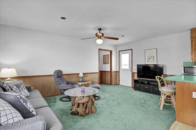 308 N Shore Dr E, Sunset Beach, NC 28468 - living room with a wainscoted wall, a ceiling fan, wooden walls, and light carpet