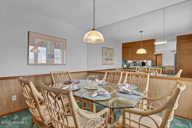 308 N Shore Dr E, Sunset Beach, NC 28468 - carpeted dining space with a wainscoted wall and wooden walls
