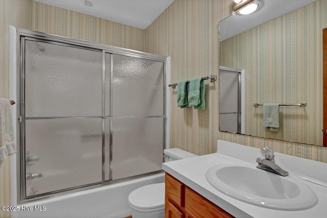 308 N Shore Dr E, Sunset Beach, NC 28468 - full bath featuring wallpapered walls, vanity, toilet, and shower / bath combination with glass door