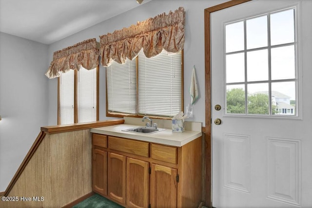 308 N Shore Dr E, Sunset Beach, NC 28468 - kitchen featuring a sink, light countertops, and brown cabinetry
