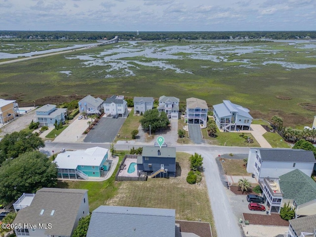 308 N Shore Dr E, Sunset Beach, NC 28468 - aerial perspective of suburban area with a large body of water and a pool area