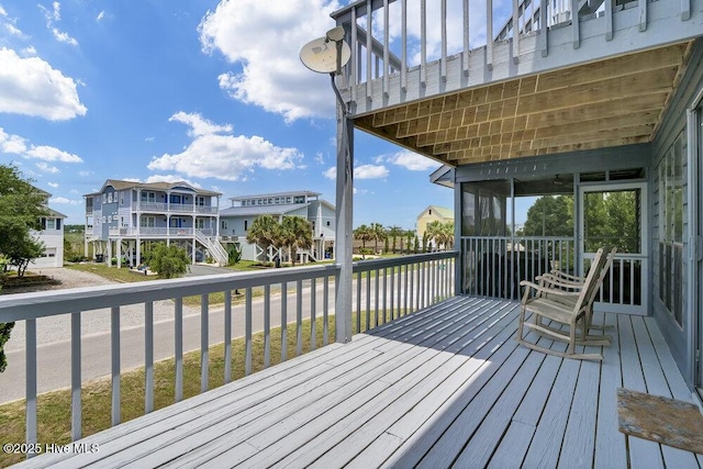 308 N Shore Dr E, Sunset Beach, NC 28468 - wooden deck with a residential view and a sunroom