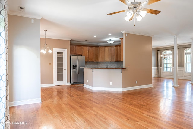 600 Booth Pond Rd, Raeford, NC 28376 - kitchen with stainless steel refrigerator with ice dispenser, a chandelier, brown cabinetry, crown molding, and tasteful backsplash