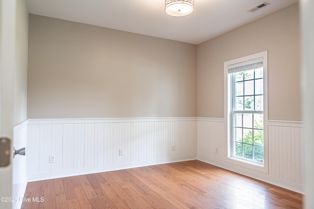 600 Booth Pond Rd, Raeford, NC 28376 - unfurnished room with a wainscoted wall and light wood-style floors