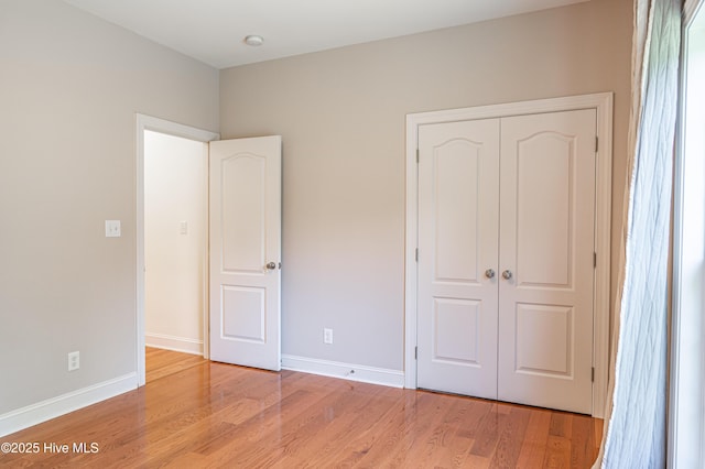 600 Booth Pond Rd, Raeford, NC 28376 - unfurnished bedroom with light wood-type flooring, a closet, and baseboards