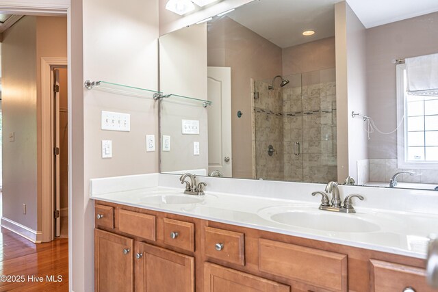 600 Booth Pond Rd, Raeford, NC 28376 - bathroom featuring a shower stall, double vanity, and wood finished floors