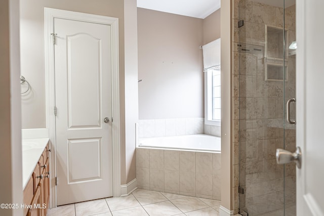 600 Booth Pond Rd, Raeford, NC 28376 - full bathroom featuring a stall shower, a garden tub, vanity, and tile patterned flooring