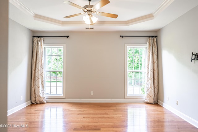 600 Booth Pond Rd, Raeford, NC 28376 - unfurnished room with a raised ceiling, plenty of natural light, ornamental molding, light wood-style flooring, and a ceiling fan