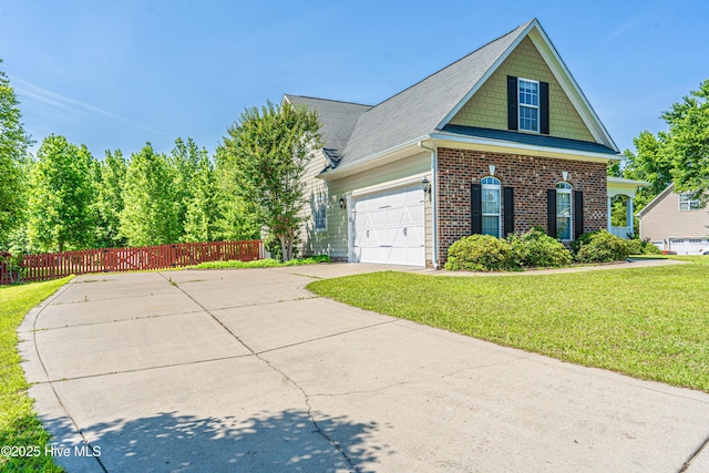 600 Booth Pond Rd, Raeford, NC 28376 - view of front of property featuring driveway, an attached garage, and brick siding