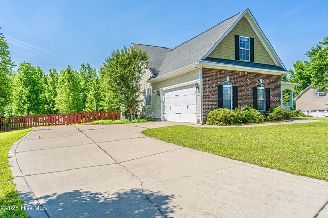 600 Booth Pond Rd, Raeford, NC 28376 - view of front of property featuring driveway, an attached garage, and brick siding