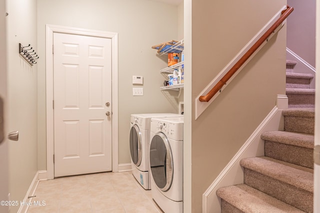 600 Booth Pond Rd, Raeford, NC 28376 - washroom featuring separate washer and dryer, light tile patterned flooring, and baseboards