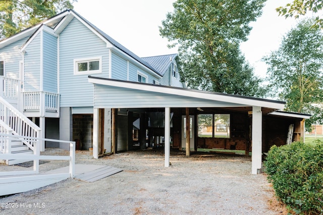 1498 Bayview Rd, Bath, NC 27808 - rear view of house featuring a carport, gravel driveway, and stairs