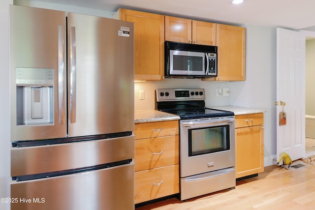 1498 Bayview Rd, Bath, NC 27808 - kitchen featuring appliances with stainless steel finishes, light wood-style flooring, recessed lighting, light brown cabinetry, and light stone counters