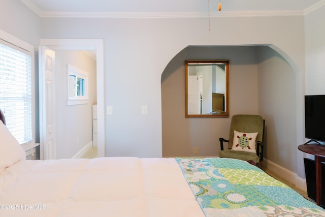 1498 Bayview Rd, Bath, NC 27808 - bedroom featuring multiple windows, arched walkways, crown molding, and baseboards