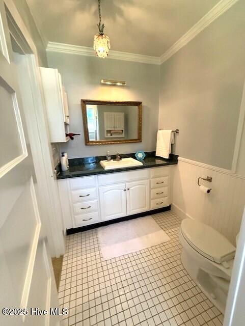 1498 Bayview Rd, Bath, NC 27808 - bathroom featuring ornamental molding, vanity, toilet, tile patterned floors, and a wainscoted wall