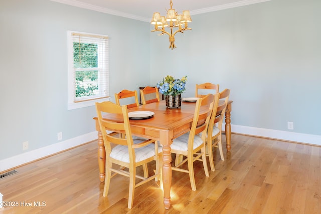 1498 Bayview Rd, Bath, NC 27808 - dining space with a chandelier, light wood-type flooring, crown molding, and baseboards