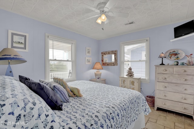 806 Channel, Topsail Beach, NC 28445 - bedroom with multiple windows, light stone finish floors, and ceiling fan