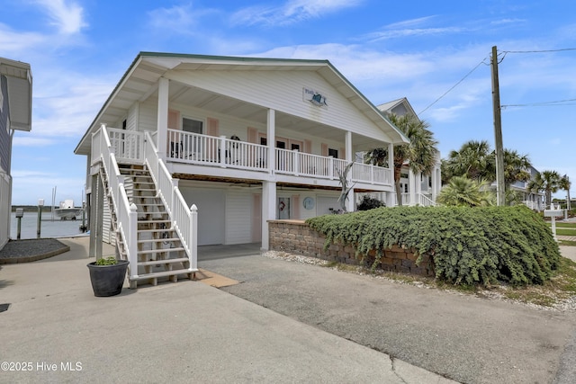 806 Channel, Topsail Beach, NC 28445 - beach home featuring stairway, driveway, a porch, and a garage