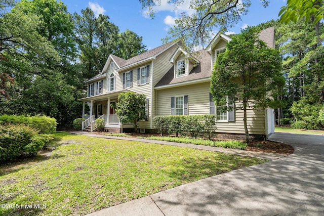 6304 Wolfhead Ct, Wilmington, NC 28411 - colonial house with a porch, a front lawn, and roof with shingles