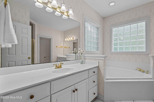 6304 Wolfhead Ct, Wilmington, NC 28411 - bathroom featuring vanity, a garden tub, and wallpapered walls