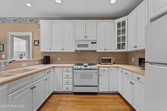 6304 Wolfhead Ct, Wilmington, NC 28411 - kitchen with white appliances, a sink, white cabinetry, recessed lighting, and light countertops