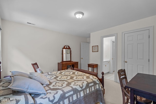 6304 Wolfhead Ct, Wilmington, NC 28411 - tiled bedroom featuring connected bathroom