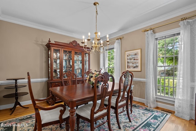 6304 Wolfhead Ct, Wilmington, NC 28411 - dining area with a chandelier, plenty of natural light, crown molding, and light wood-style flooring