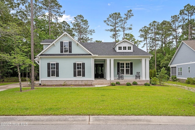 633 Ashbury Dr SE, Bolivia, NC 28422 - view of front of property featuring covered porch, a front lawn, and a shingled roof