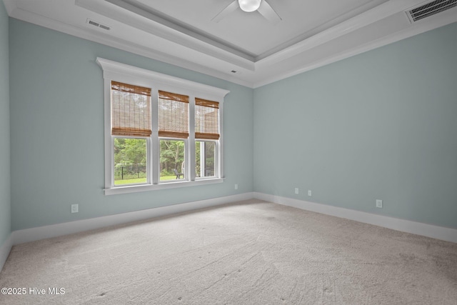 633 Ashbury Dr SE, Bolivia, NC 28422 - carpeted spare room with a raised ceiling, a ceiling fan, ornamental molding, and baseboards