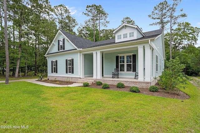 633 Ashbury Dr SE, Bolivia, NC 28422 - view of front facade featuring covered porch and a front lawn