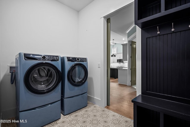 633 Ashbury Dr SE, Bolivia, NC 28422 - washroom featuring independent washer and dryer, baseboards, and wood finished floors
