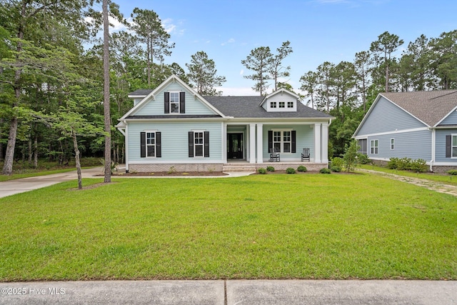 633 Ashbury Dr SE, Bolivia, NC 28422 - view of front of house featuring a porch, a front lawn, and roof with shingles