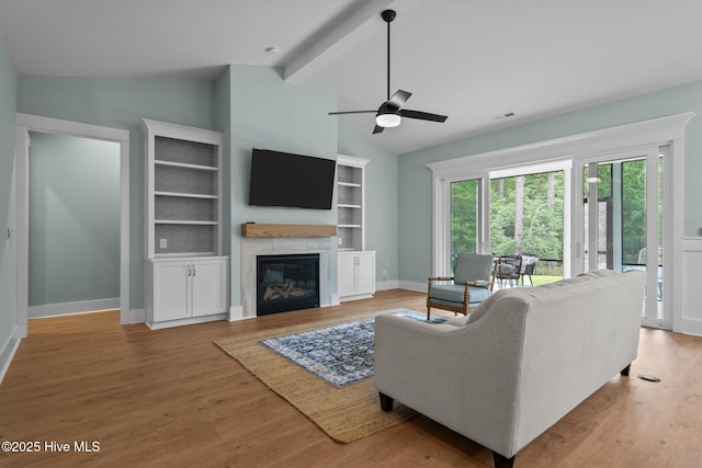 633 Ashbury Dr SE, Bolivia, NC 28422 - living area featuring a ceiling fan, a tile fireplace, baseboards, and light wood-type flooring