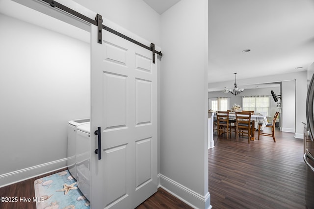 14 Allbrook Way, Hampstead, NC 28443 - hallway featuring a barn door, a chandelier, dark wood-style floors, and baseboards