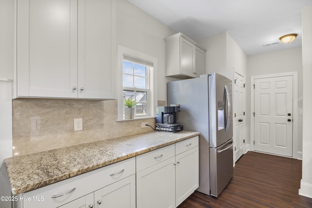 14 Allbrook Way, Hampstead, NC 28443 - kitchen with stainless steel fridge, dark wood finished floors, tasteful backsplash, light stone countertops, and white cabinetry