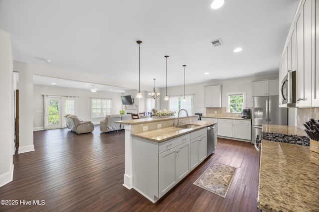 14 Allbrook Way, Hampstead, NC 28443 - kitchen with a sink, appliances with stainless steel finishes, open floor plan, decorative backsplash, and dark wood-type flooring