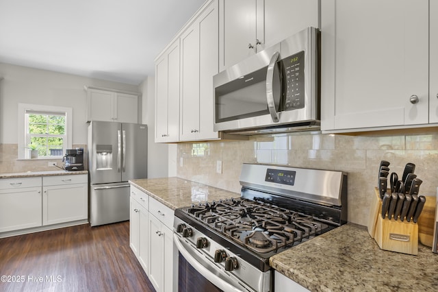 14 Allbrook Way, Hampstead, NC 28443 - kitchen with appliances with stainless steel finishes, decorative backsplash, white cabinets, light stone counters, and dark wood-style flooring