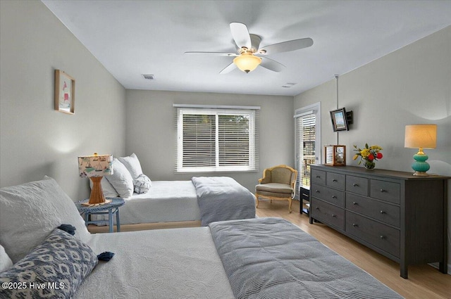 816 Colony Pl Unit D, Sunset Beach, NC 28468 - bedroom featuring light wood-style floors and a ceiling fan