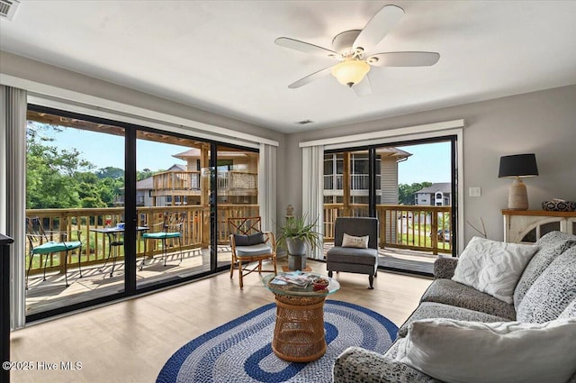816 Colony Pl Unit D, Sunset Beach, NC 28468 - living room with plenty of natural light, a ceiling fan, and wood finished floors